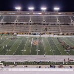 Un stade de football américain éclairé la nuit, symbole de la NFL au cœur d'une polémique médicale autour d'un quarterback