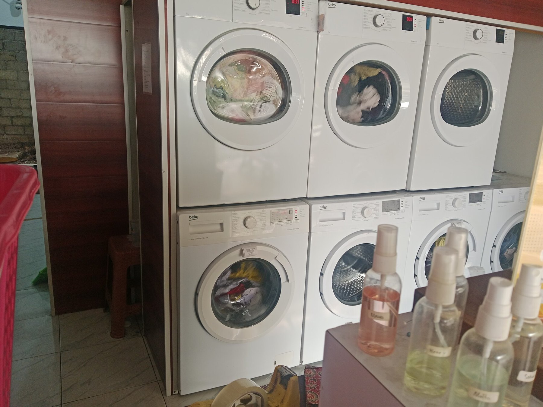 Sacs de courses en tissu réutilisables posés sur une table en bois, à côté de bocaux en verre